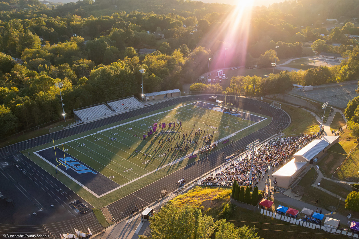 An aerial image of Enka High's football field as a marching band begins their performance.