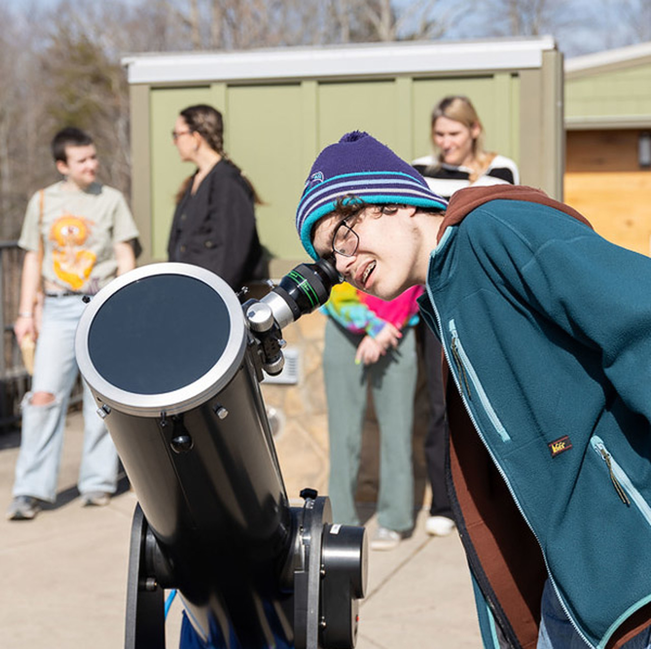 A Virtual Academy student looks at the sun through a solar-shielded telescope.