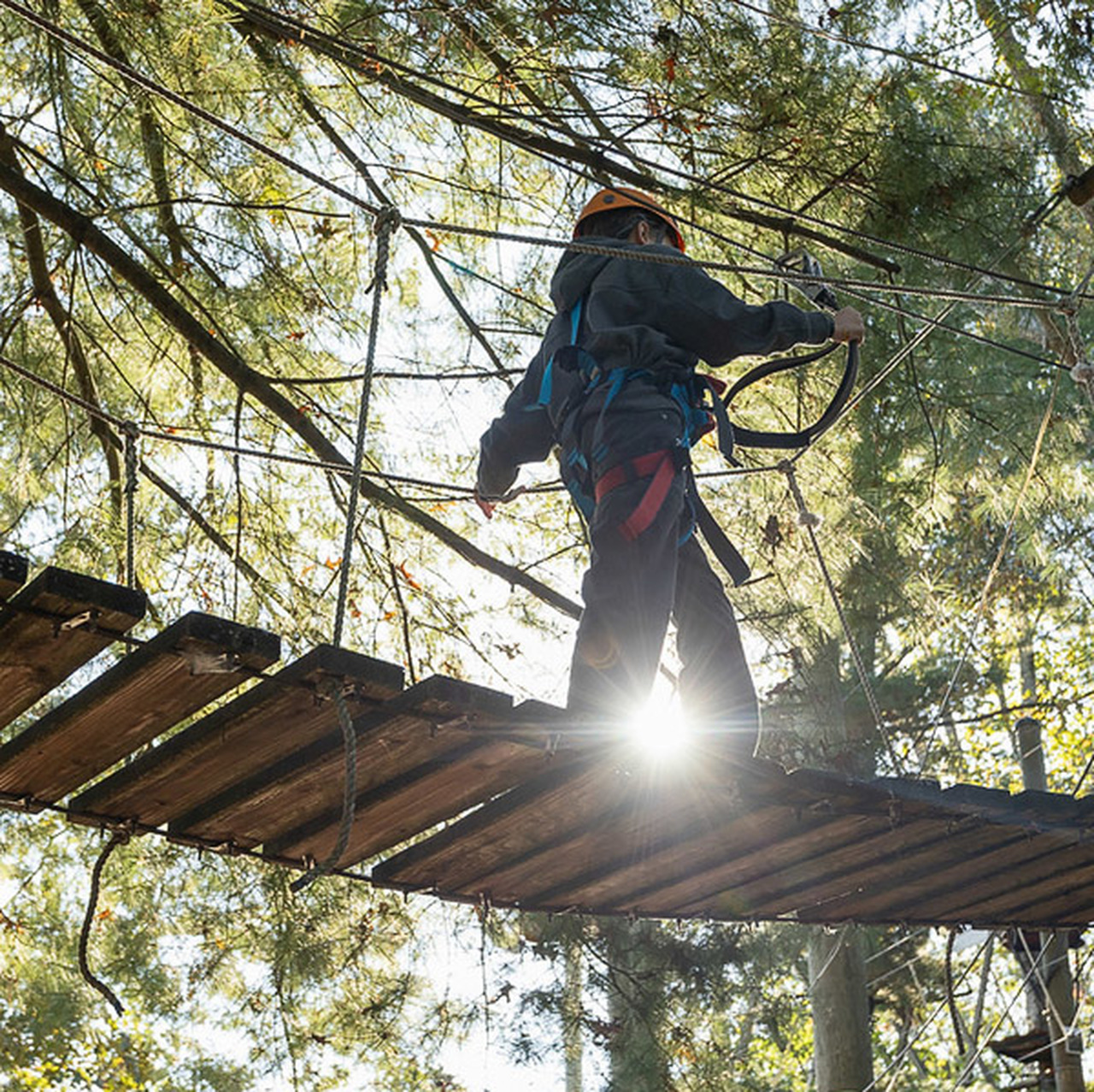 A North Buncombe Middle School student walks across part of the ropes course at Adventure Center of Asheville.