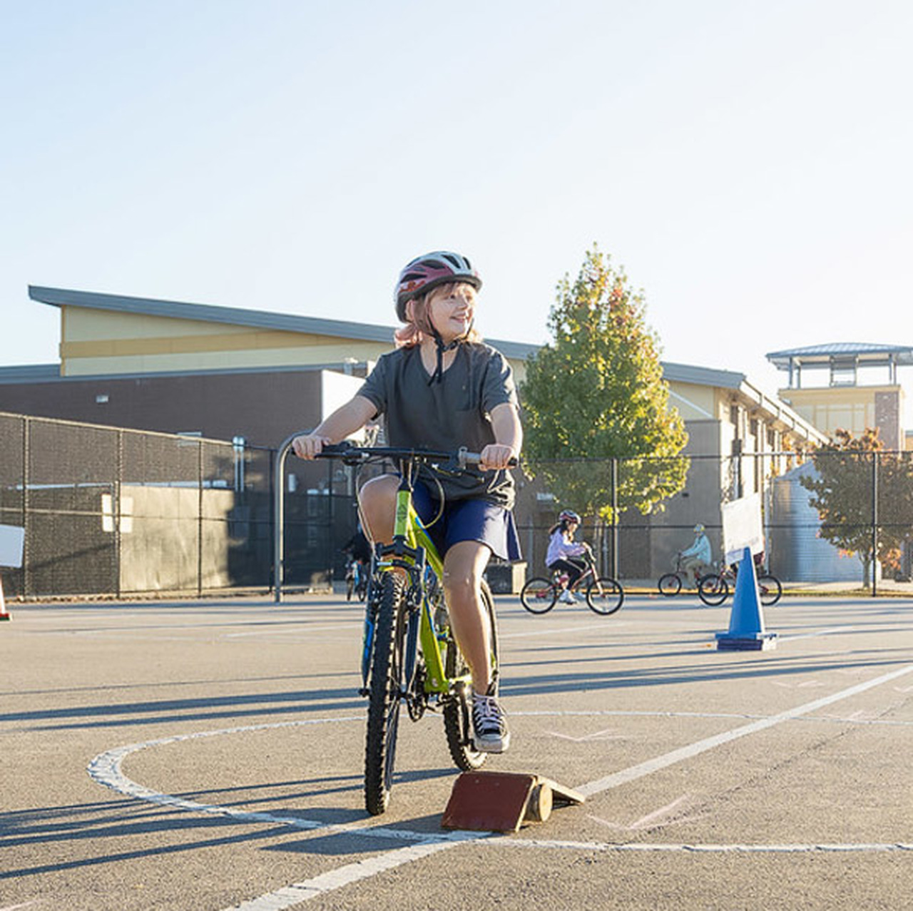 A student looks to her left while riding a bicycle at Enka Intermediate School.