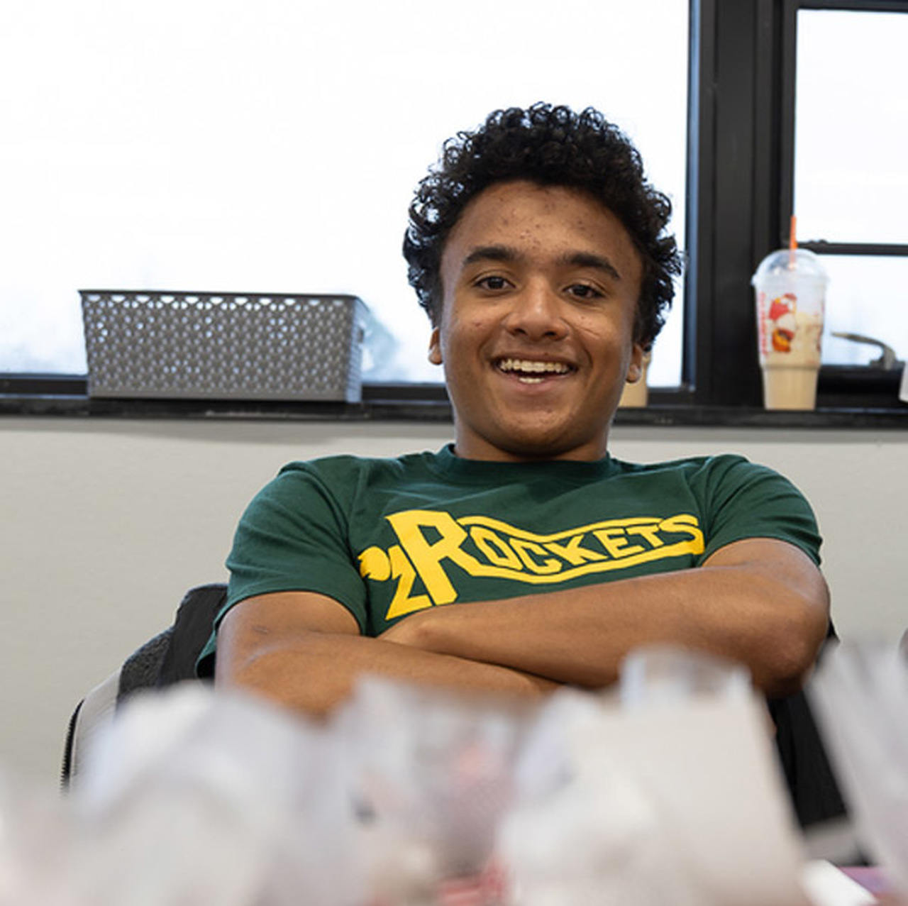 A student smiles with crossed arms at the Craft Bazaar