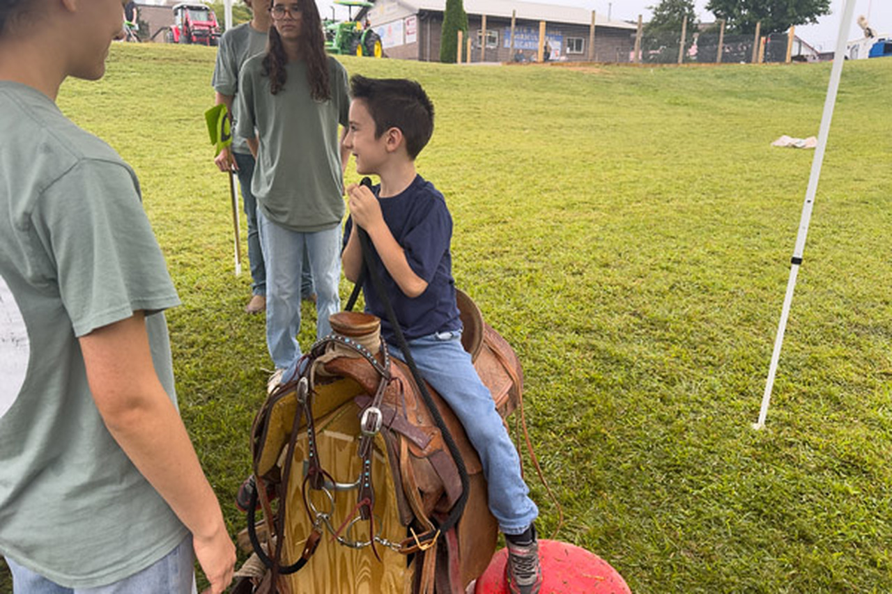 A student sits on a saddle.