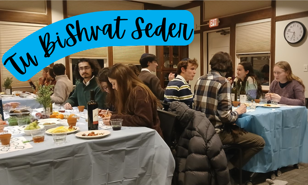 Students sitting at tables observing Tu Bishvat Seder