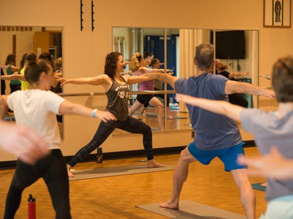 Four people in the photo are doing yoga