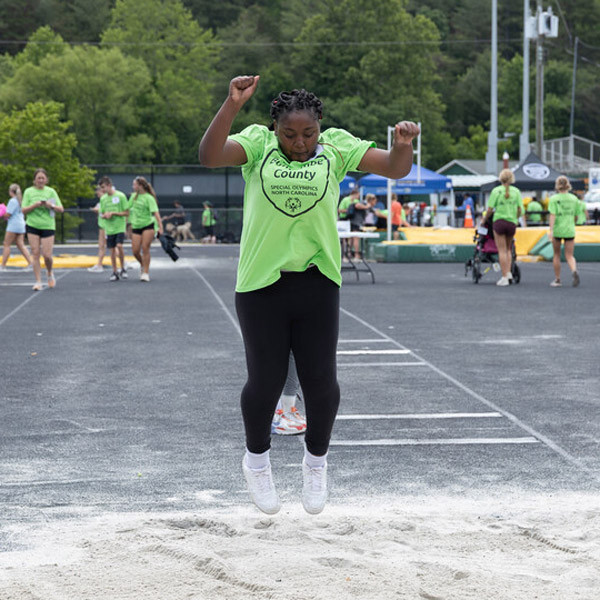 A student participates in a long jump contest.