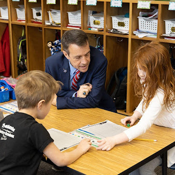 Dr. Jackson interacts with students at an elementary school.