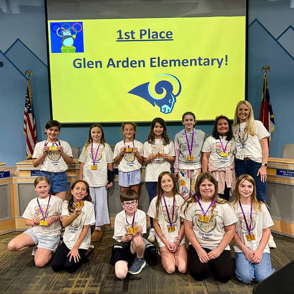 The first place Glen Arden Elementary team poses in front of a congratulatory screen.