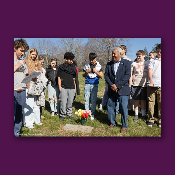 Buncombe County Commissioner Al Whitesides joins Valley Springs students at a graveside.