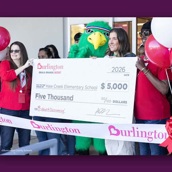Representatives from Haw Creek Elementary and Burlington Coat Factory hold a $5,000 novelty check.