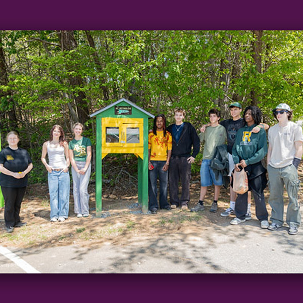 Students and an SRO pose in front of the food pantry.