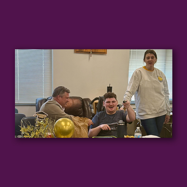 BCS Assistant Superintendent Chip Cody interacts with a student and another adult.