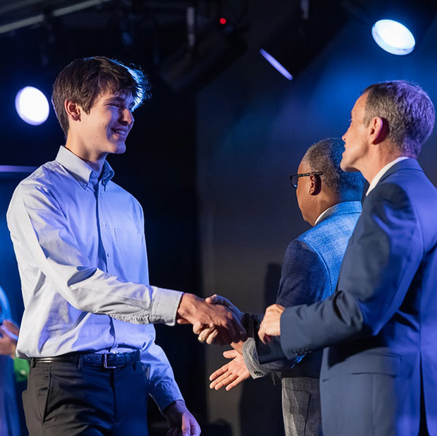 Michael Schruckmayr of Nesbitt Discovery Academy shakes BCS Superintendent Dr. Rob Jackson's hand during the 2026 Top Scholar ceremony.