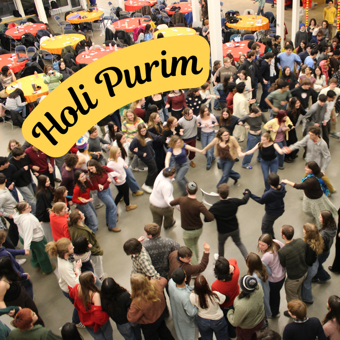 Large gathering of student, faculty, and staff dancing the hora at Holi Purim