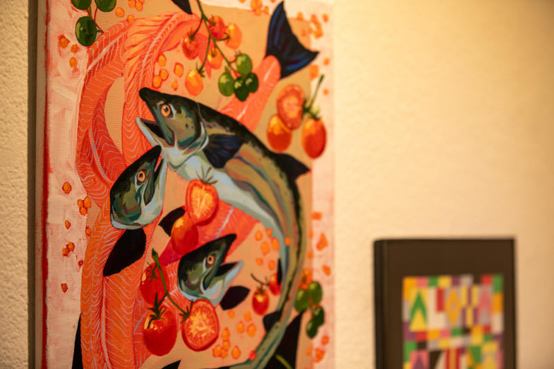 A painting with two salmon and different fruits and berries.